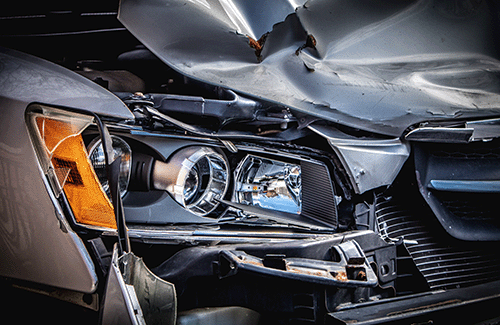 Closeup of a damaged vehicle's headlight.