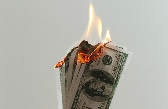 Several $100 bills on fire