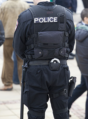 Back view of a fully equipped Police Officer.