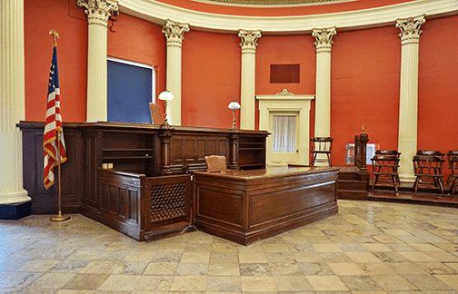 An empty courtroom with orange walls.